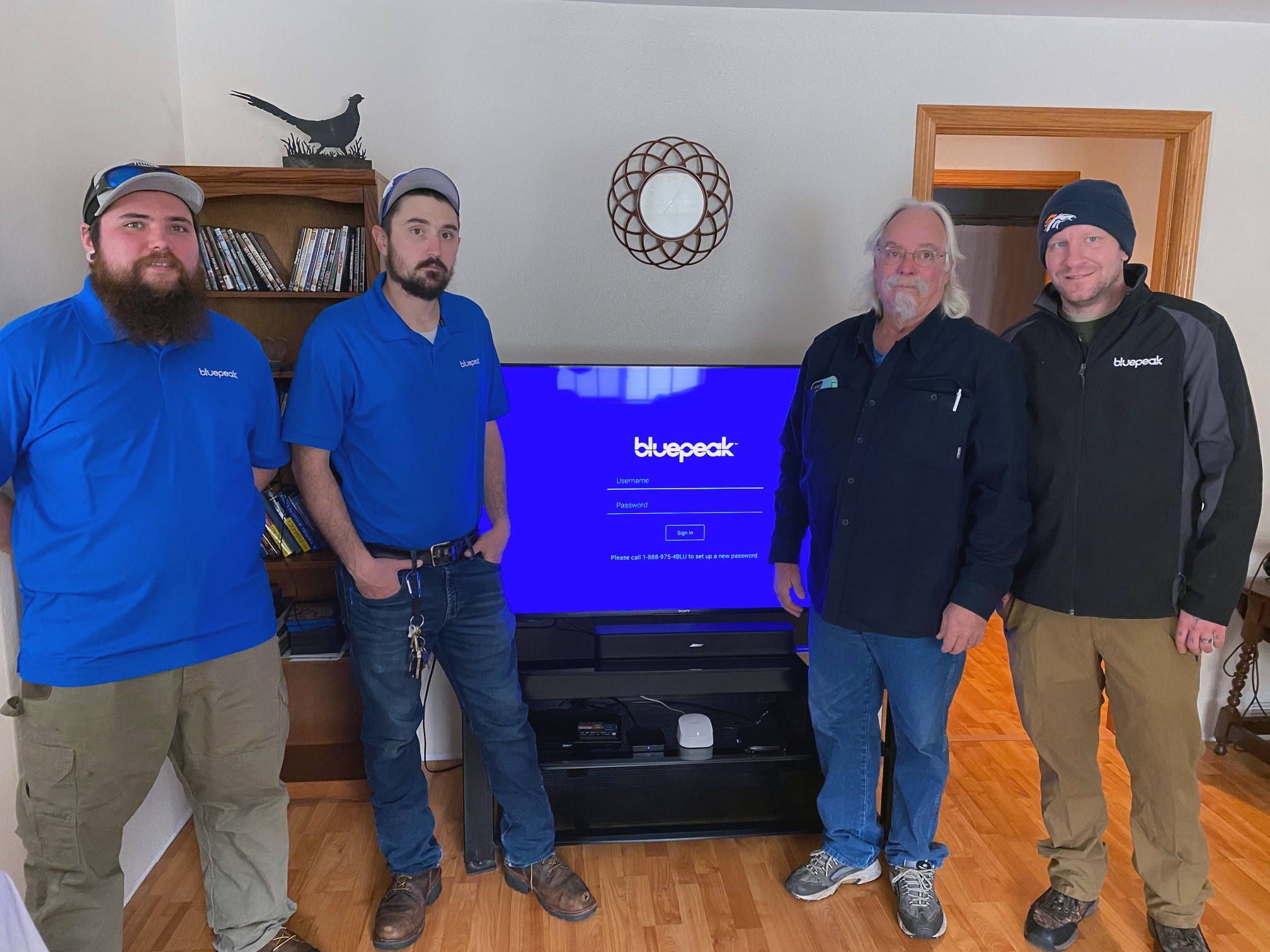 Bluepeak's Derreck Easley, Christian Hauf and Wesley Foster (left to right) pose with Gary Powell, our first customer in Sheridan, Wyo.