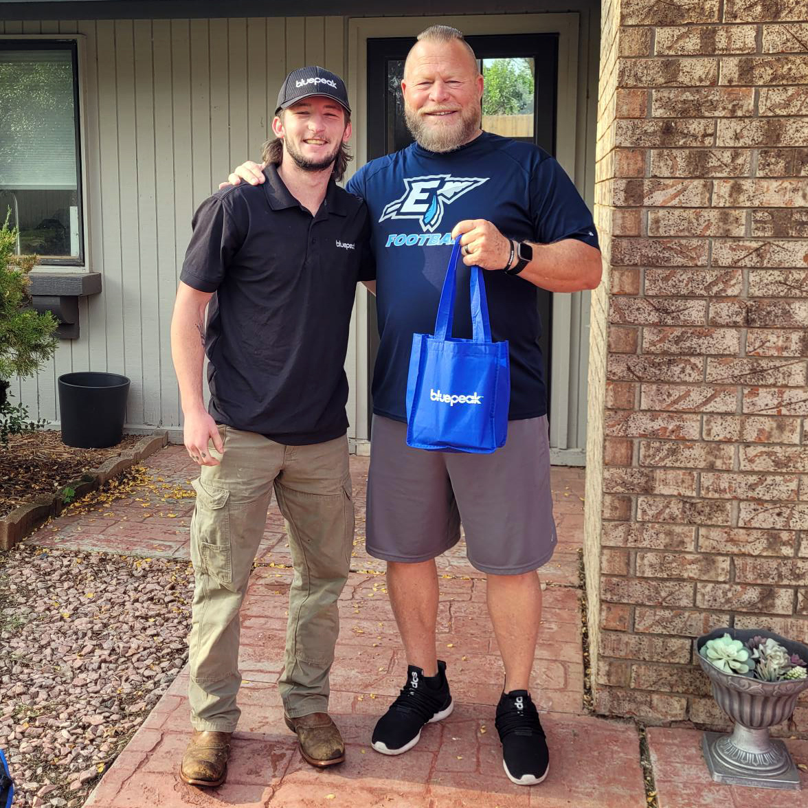 Rick Luetjen, pictured with Installation Technician Matthew Clark, became Bluepeak’s 2,000th subscriber in Enid, Oklahoma, on Thursday, June 1, 2023.