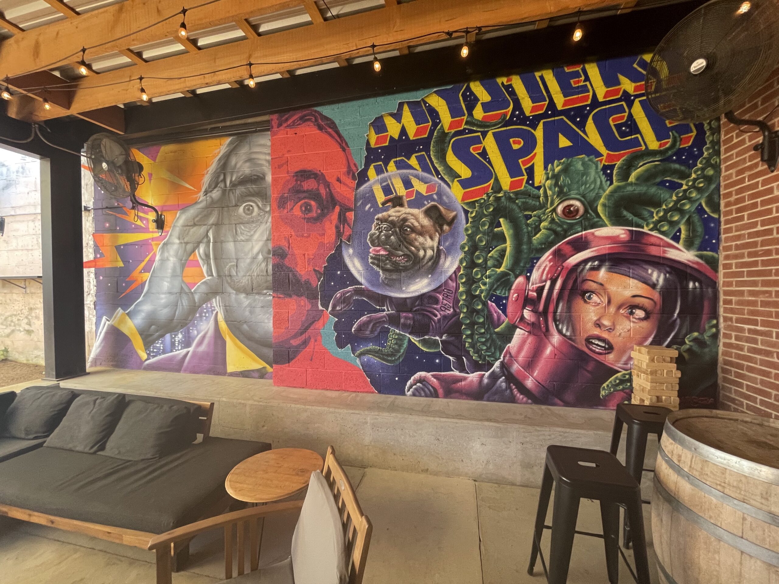 The back patio of Stonecloud Brewing, adorned with a mural done by a local artist.