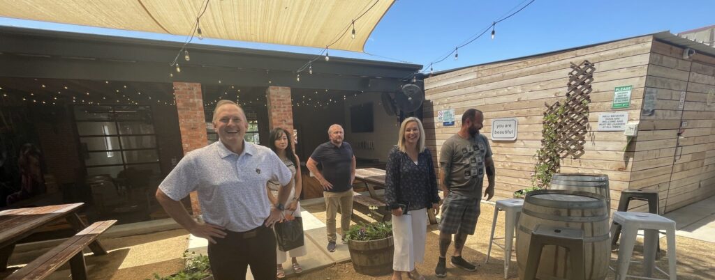 People stand in the outdoor patio space at Stonecloud Brewing.