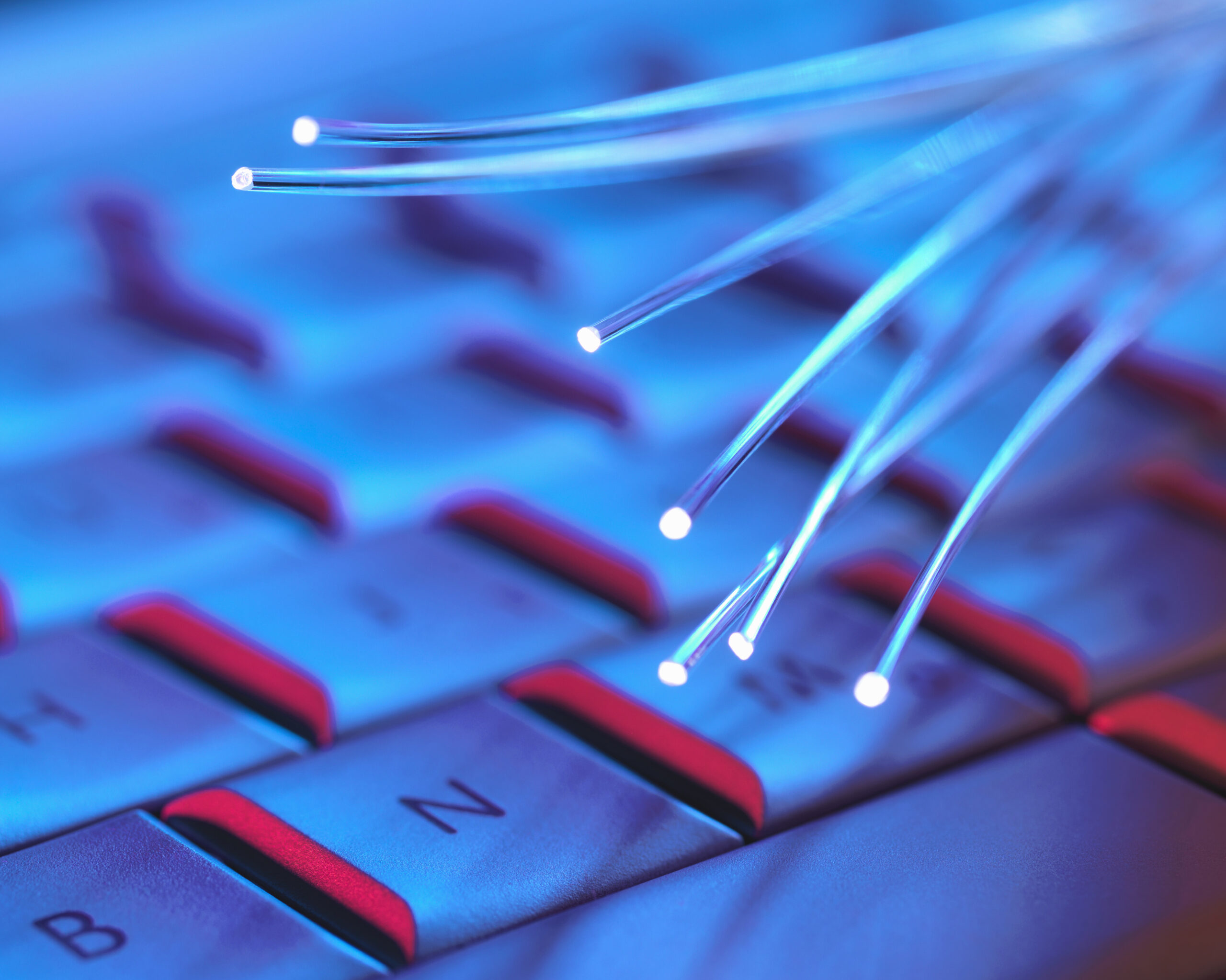 Optical fibers, used to carry high volumes of data, over a computer keyboard
